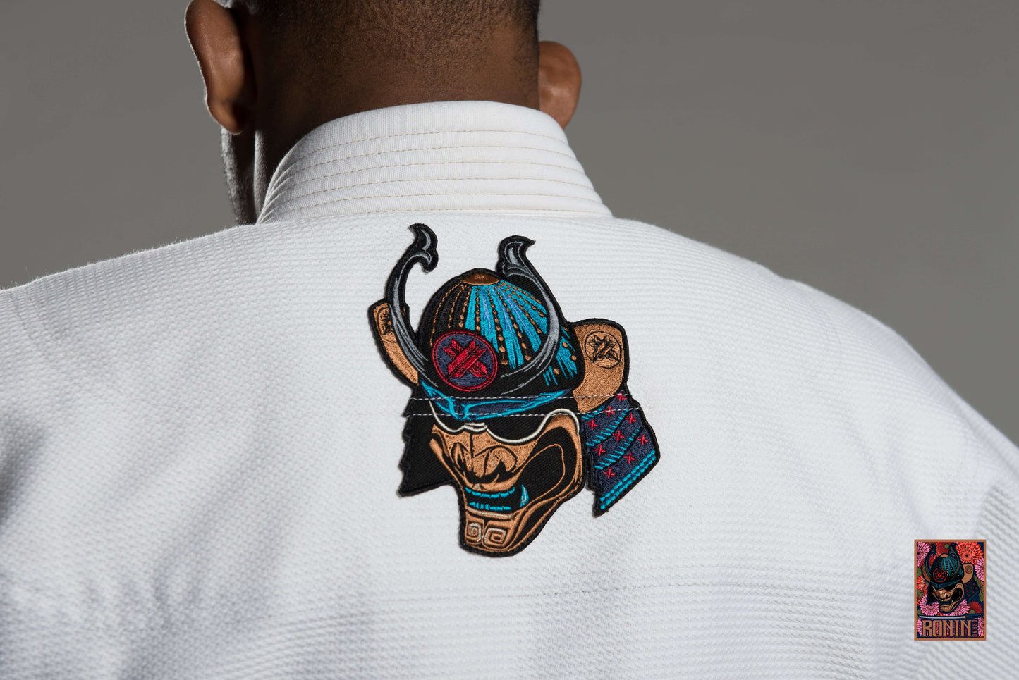 Back view of Roninbrand Emperor BJJ Gi featuring intricate samurai embroidery on a white fabric.