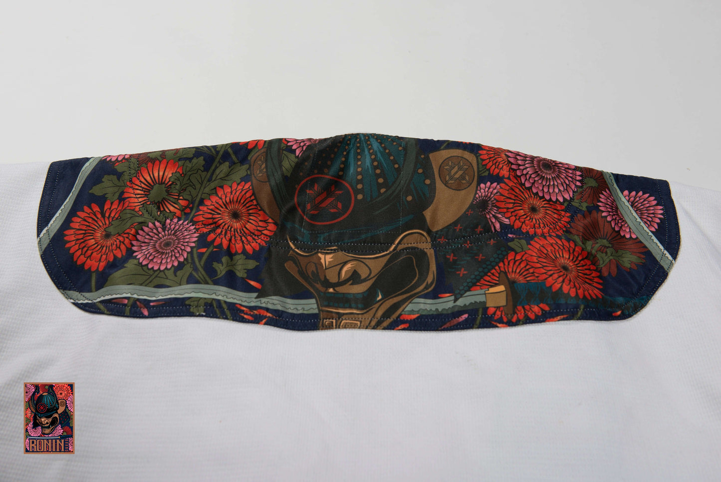 Samurai mask design with colorful flowers on a martial arts uniform, showcasing Roninbrand's Emperor BJJ Gi.
