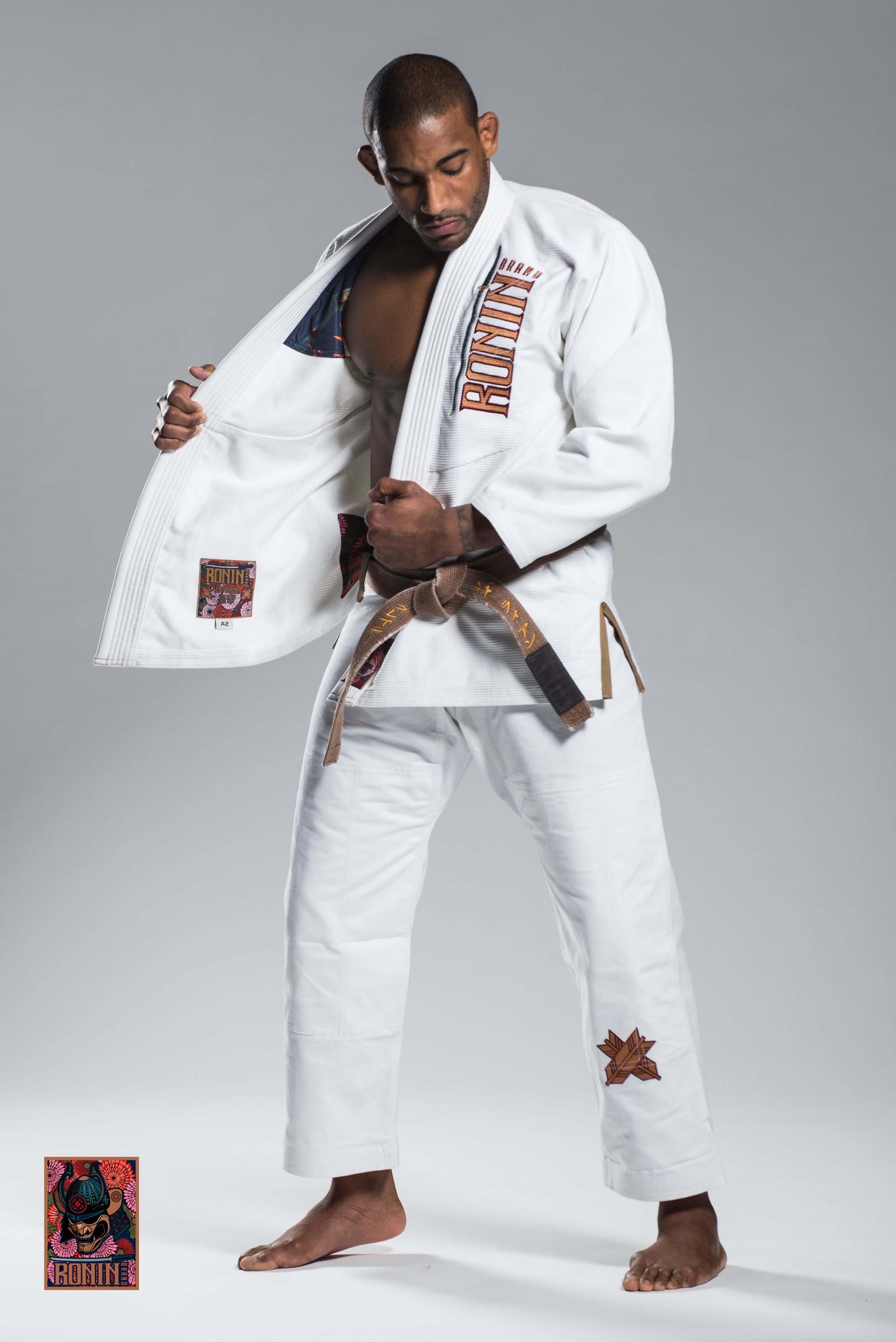Man demonstrating Roninbrand Emperor BJJ Gi in white, showcasing comfort and design for Brazilian Jiu Jitsu training.