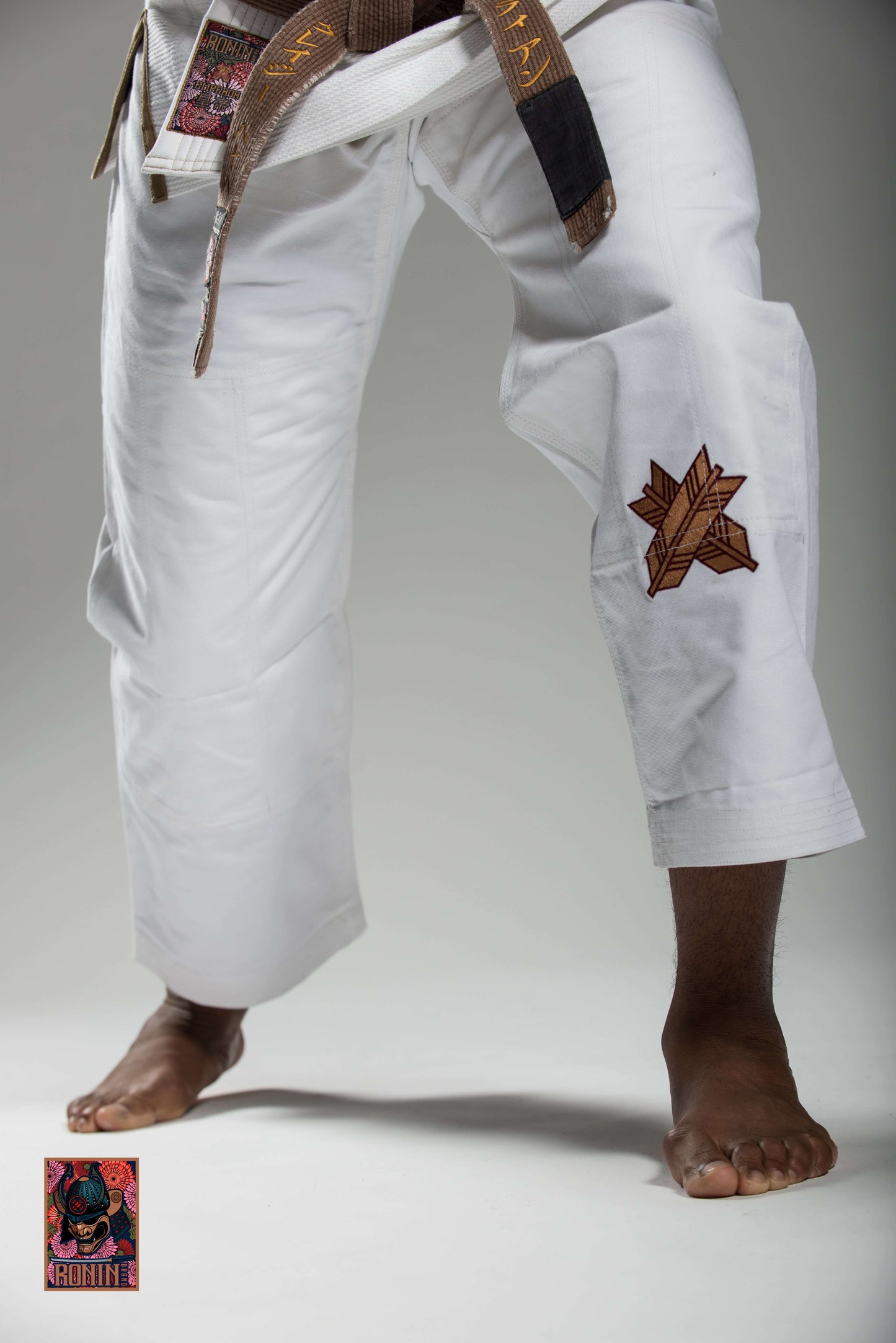 Roninbrand Emperor BJJ Gi in white, showcasing intricate chrysanthemum embroidery, designed for grappling and combat.
