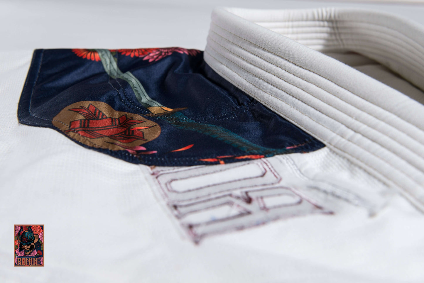 Close-up of the Roninbrand Emperor BJJ Gi collar featuring embroidered chrysanthemum design.