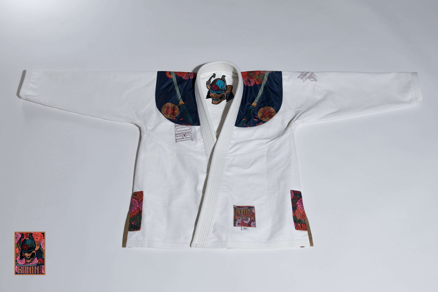 Roninbrand Emperor BJJ Gi in white with intricate chrysanthemum embroidery, designed for optimal comfort and performance in combat.