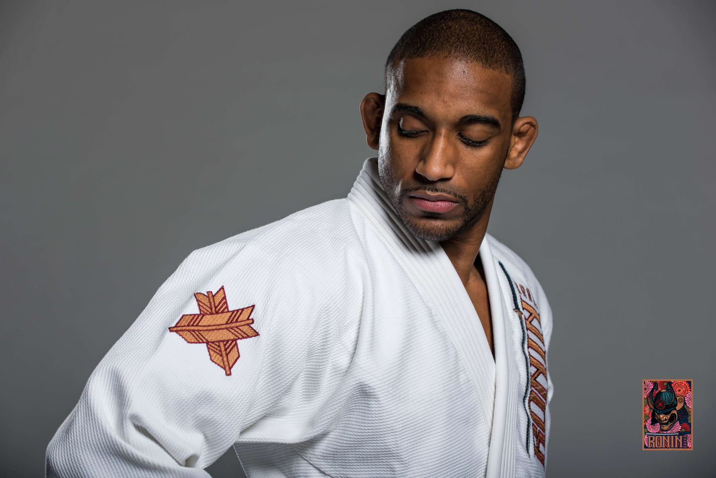 Roninbrand Emperor BJJ Gi in white, showcasing intricate chrysanthemum embroidery, designed for optimal grappling performance.