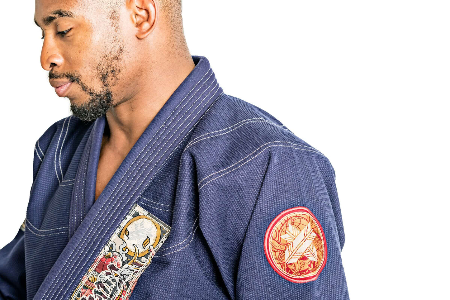 Man wearing Roninbrand Oni Bushi Navy BJJ Gi showcasing intricate design, highlighting comfort and fit for elite fighters.
