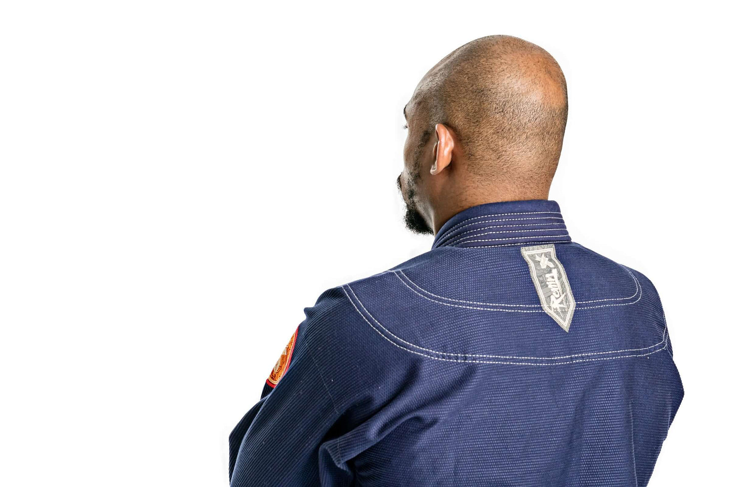 Rear view of a man wearing the Roninbrand Oni Bushi Navy BJJ Gi, showcasing its quality design and craftsmanship.