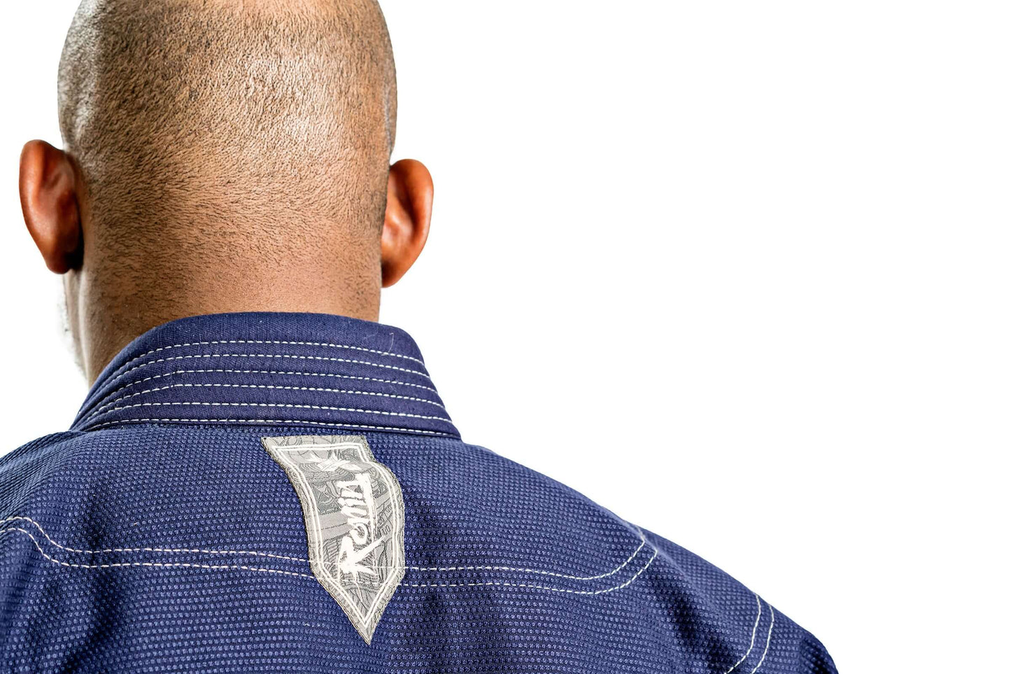 Back view of a man wearing the Roninbrand Oni Bushi Navy BJJ Gi, showcasing its design and logo.