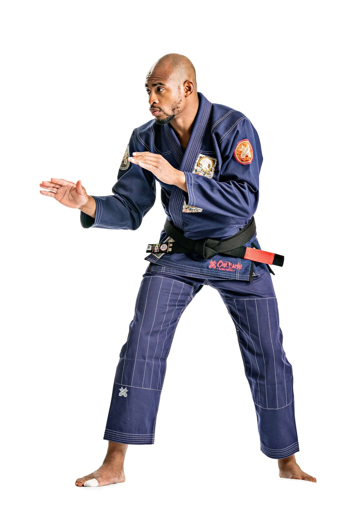 Man demonstrating BJJ technique in Navy Roninbrand Oni Bushi Gi, showcasing style and skill in martial arts.