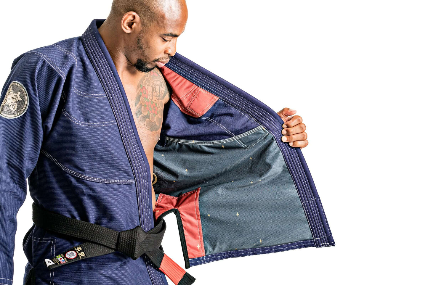 Man showcasing the inner lining of Roninbrand Oni Bushi Navy BJJ Gi, highlighting comfort and design for fighters.