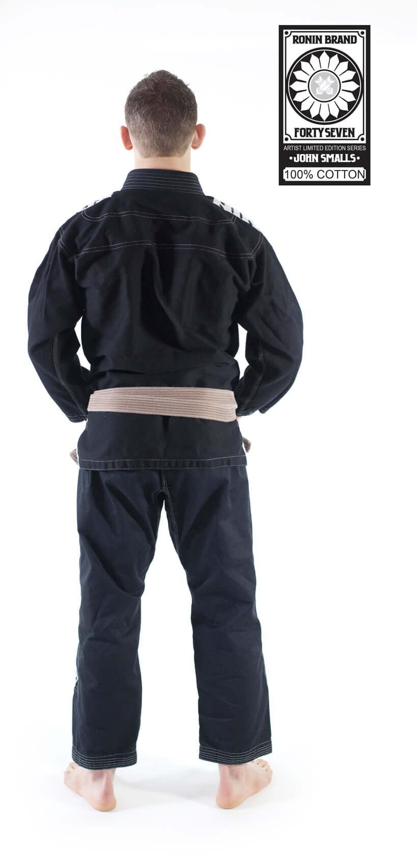 Back view of a man wearing the Roninbrand 47 BJJ Gi in black with a brown belt, showcasing comfort and fit for serious fighters.