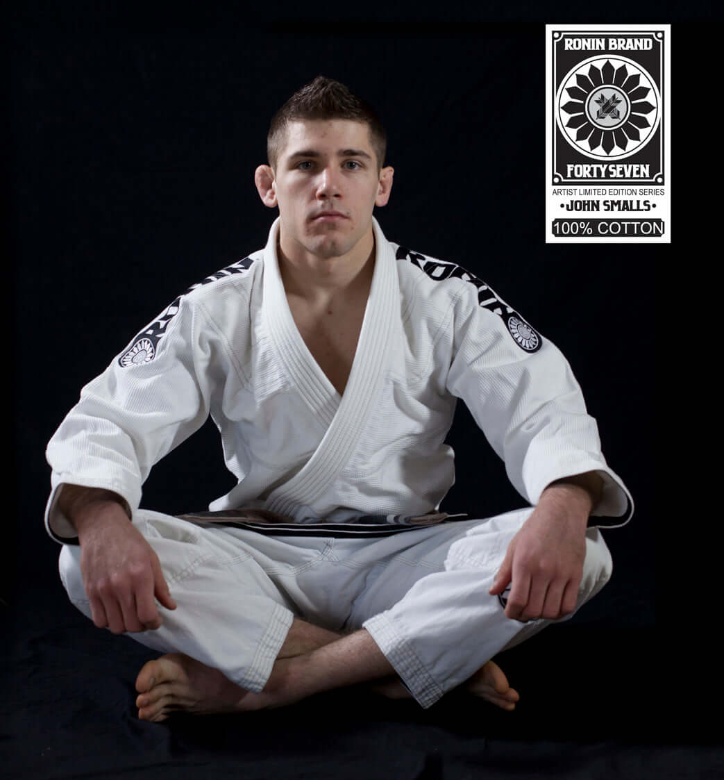 Roninbrand 47 BJJ Gi in white, modeled by John Smalls, showcasing professional Brazilian Jiu Jitsu craftsmanship and comfort.