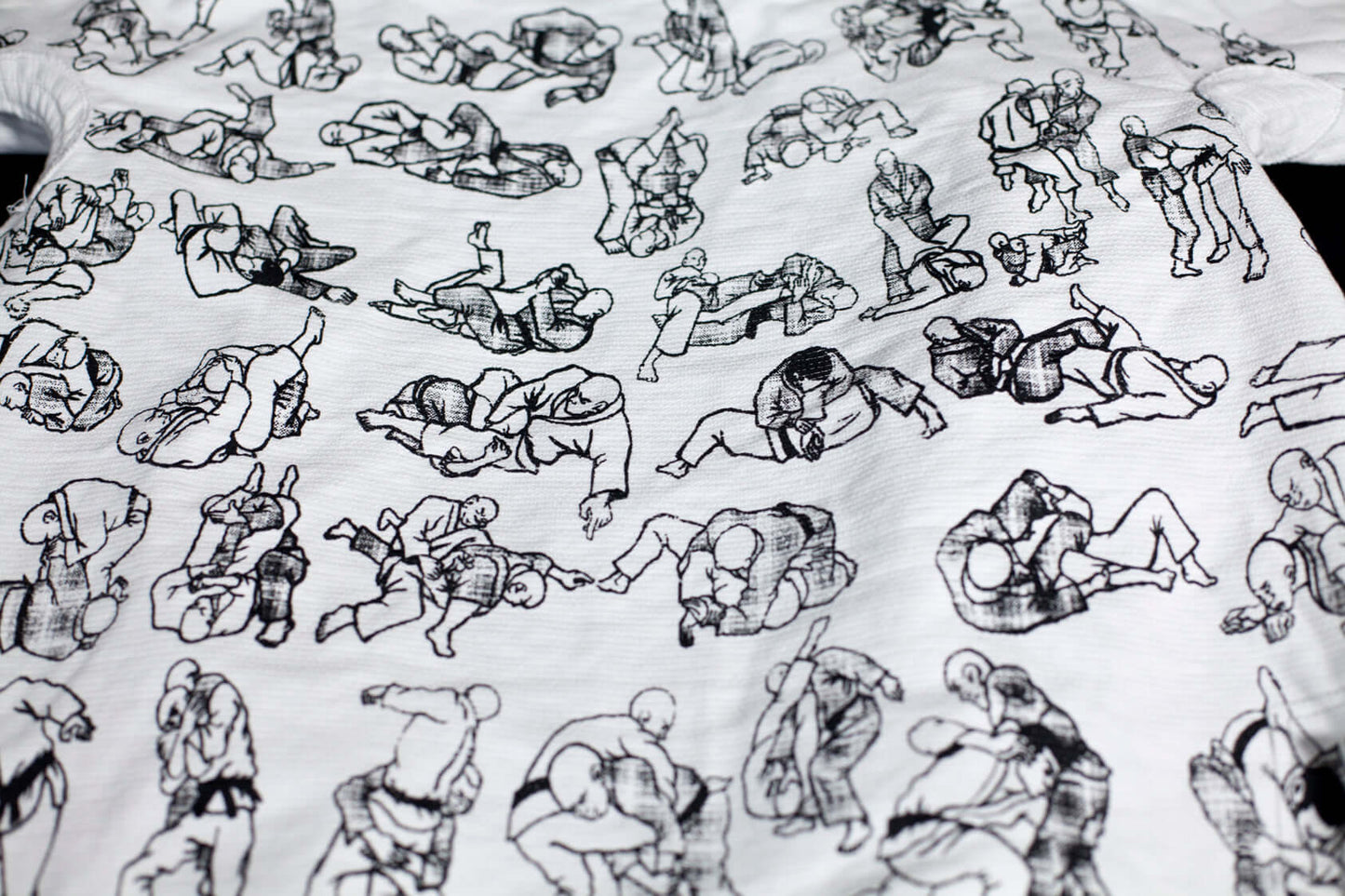 White t-shirt featuring various grappling illustrations, showcasing Brazilian Jiu Jitsu techniques.