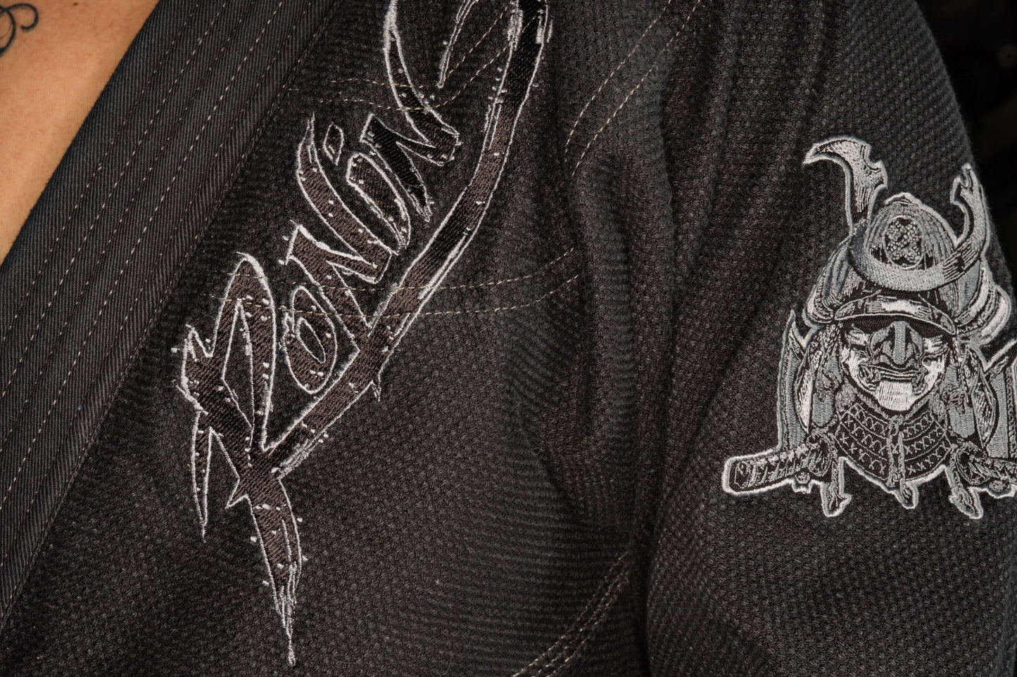 Close-up of Ronin brand logo and samurai design on Blackout Samurai Ghost BJJ Gi, representing elite craftsmanship.