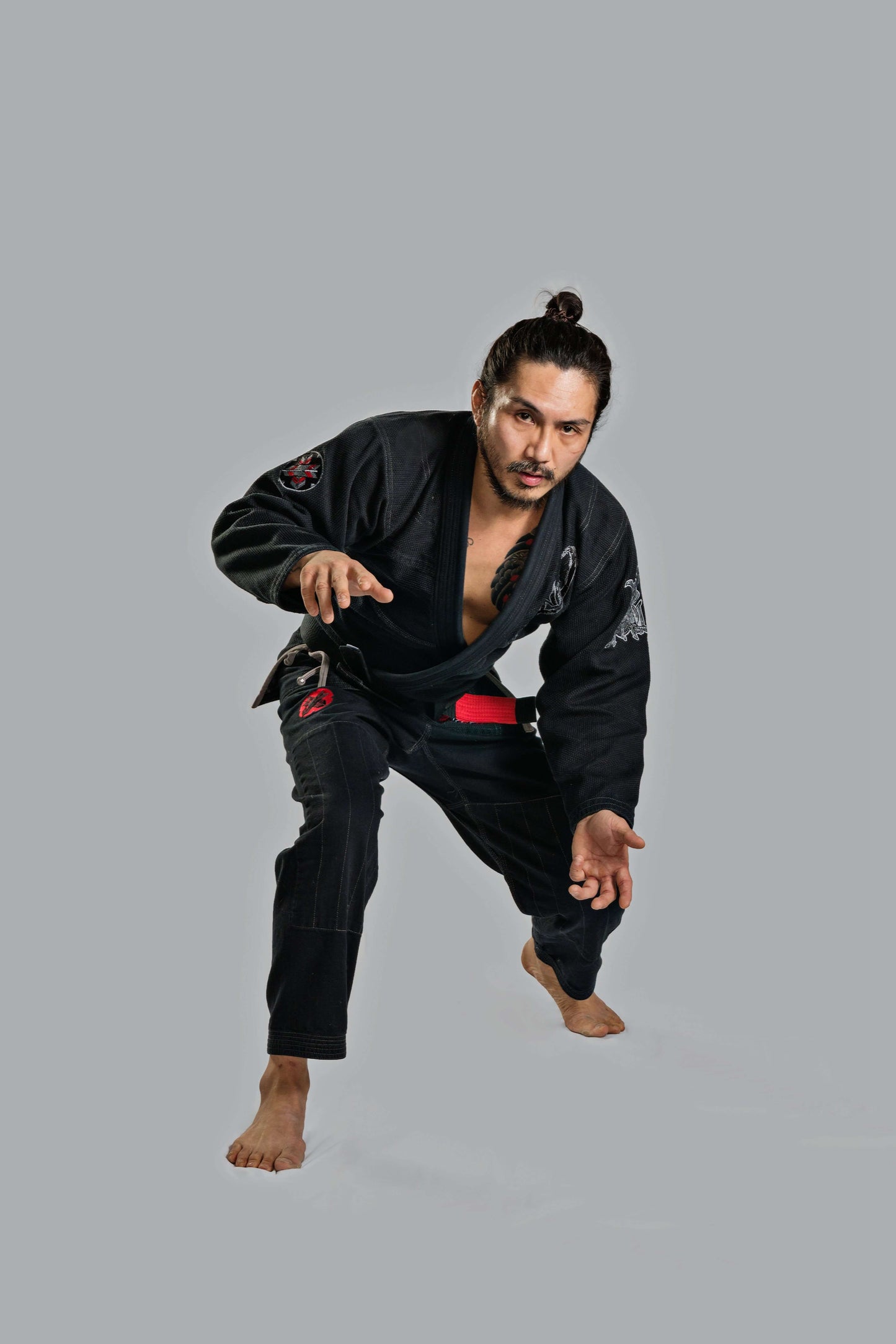 Roninbrand Samurai Ghost BJJ Gi in black worn by a fighter poised for action, showcasing superior fit and design.