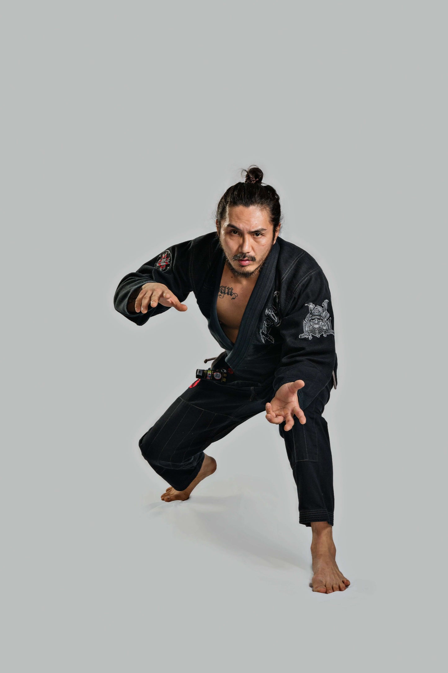 Man in black Roninbrand Samurai Ghost BJJ Gi, showcasing readiness and strength for Brazilian Jiu Jitsu.