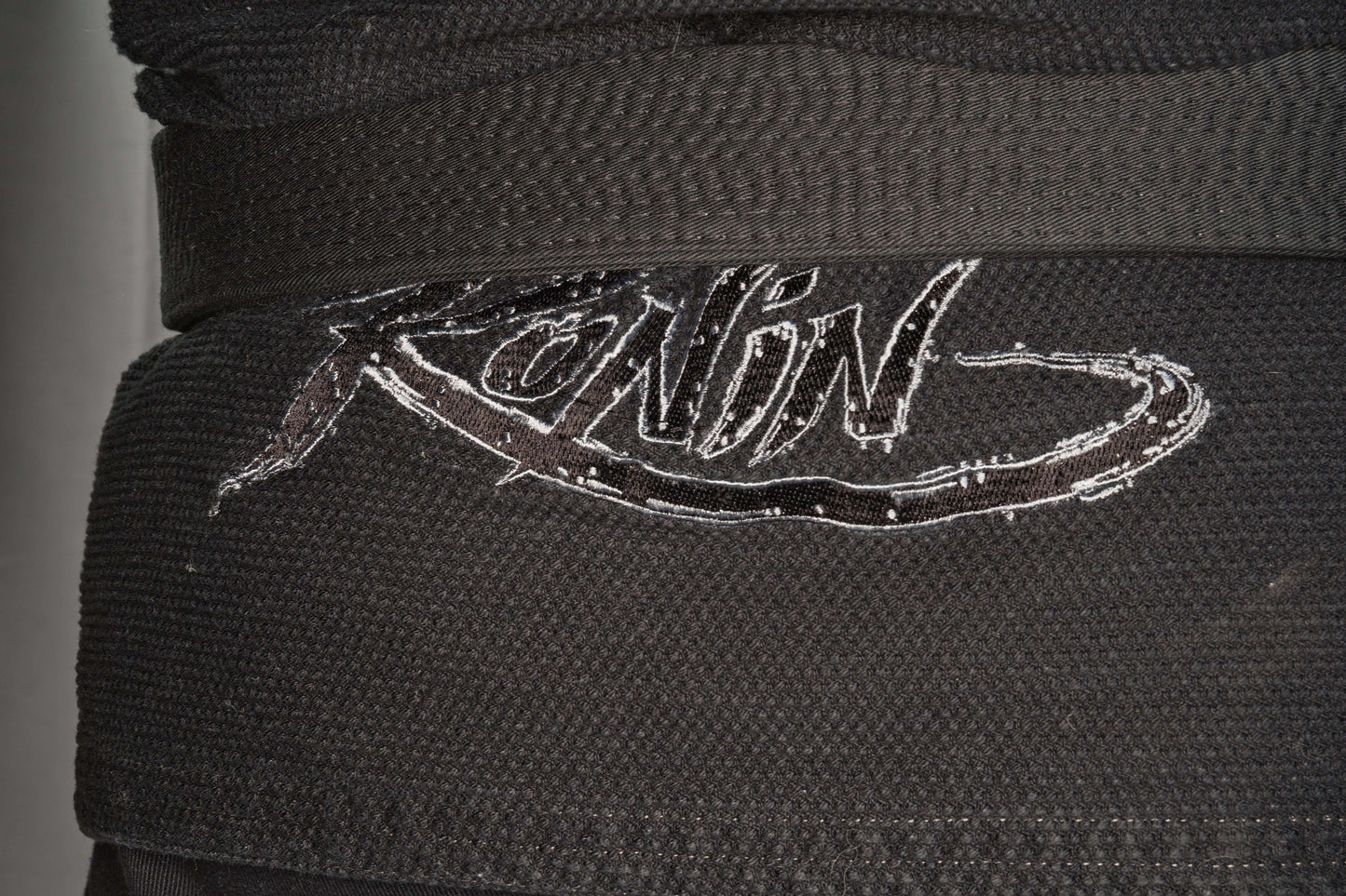 Close-up of Ronin logo on the black Samurai Ghost BJJ Gi, showcasing its quality and design for elite fighters.