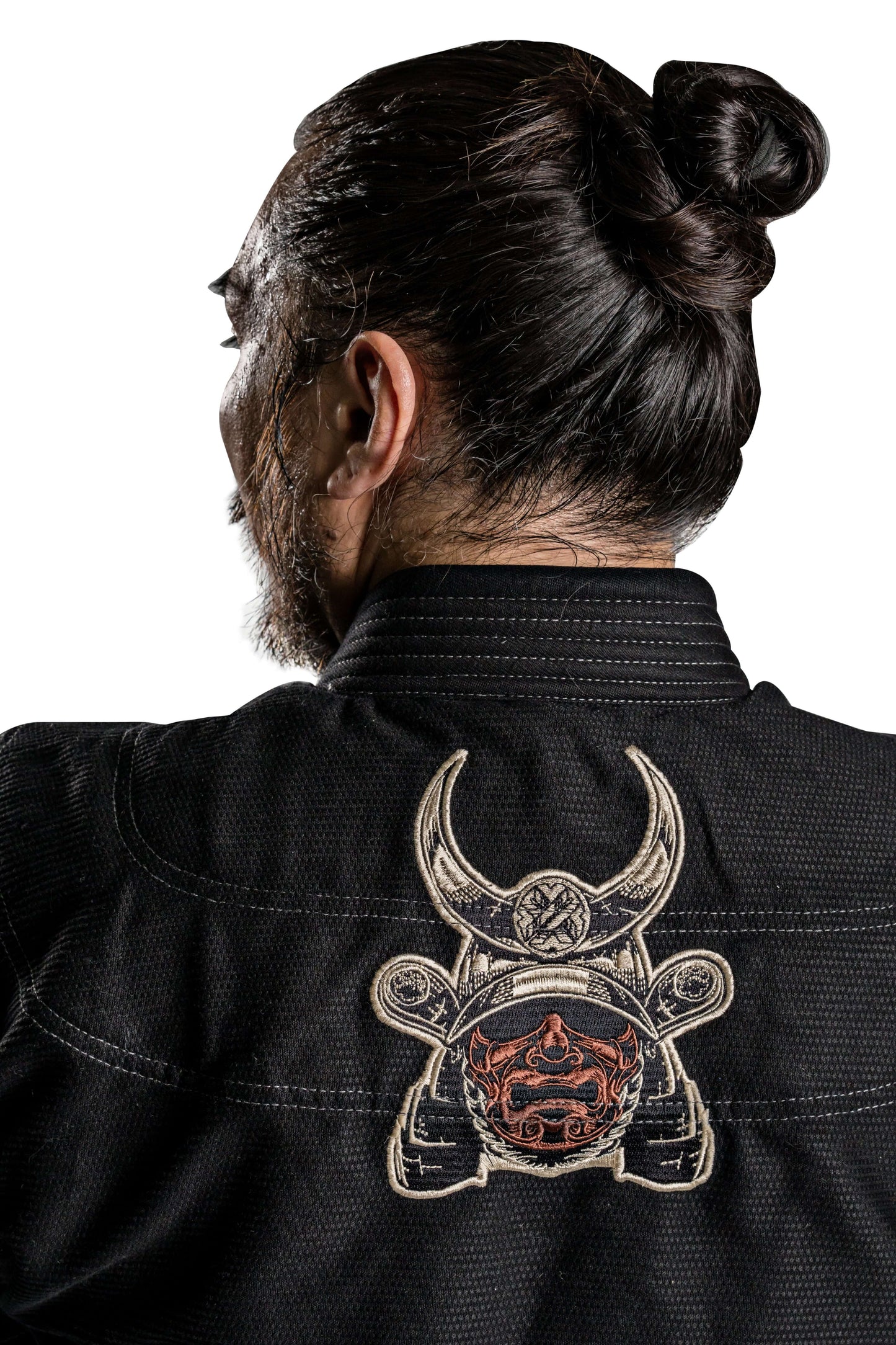 Back view of a man wearing Roninbrand Kurosawa BJJ Gi with samurai design, showcasing craftsmanship and style.