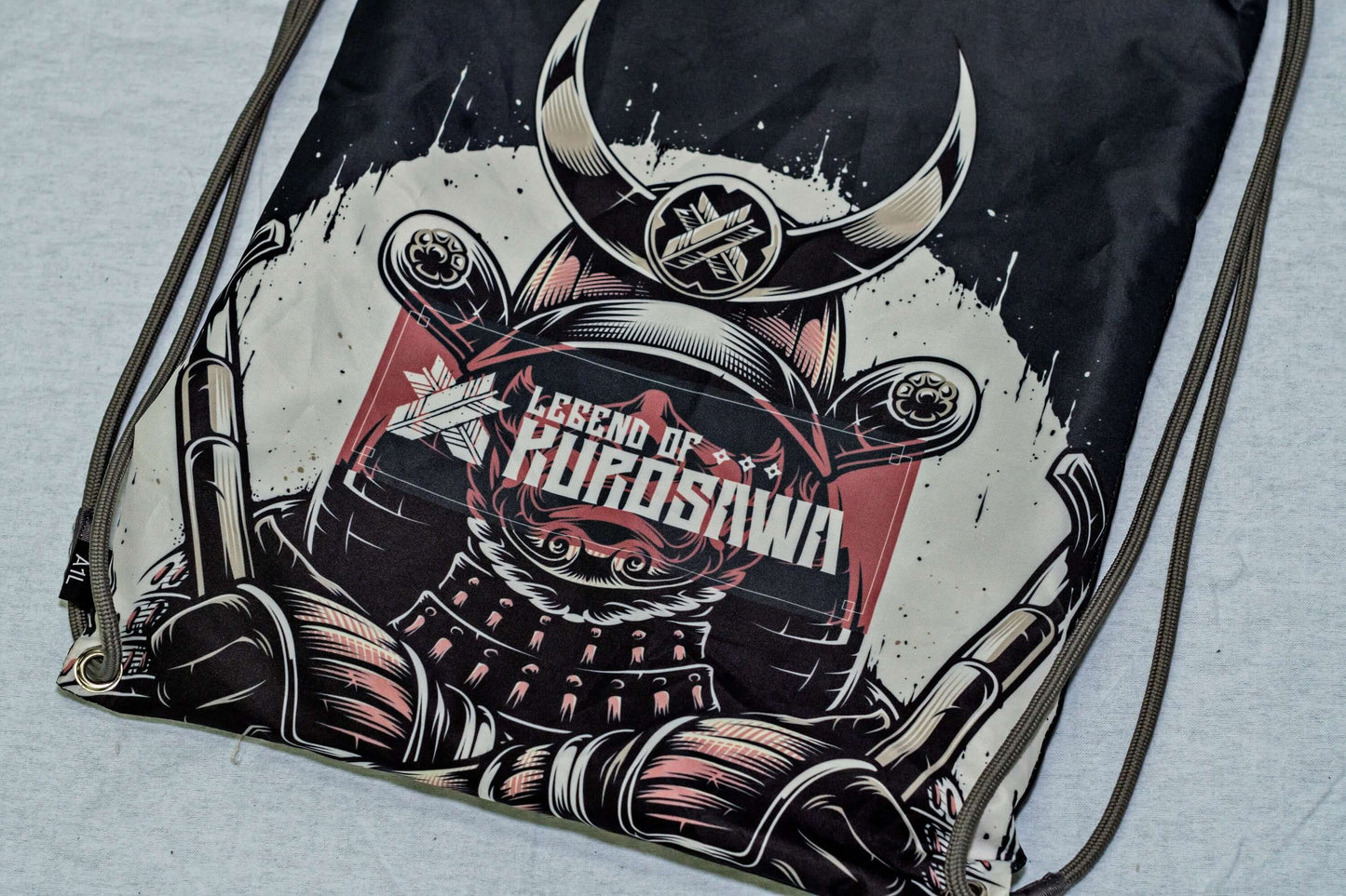 Legend of Kurosawa graphic drawstring bag featuring a samurai design, inspired by Akira Kurosawa's cinematic legacy.