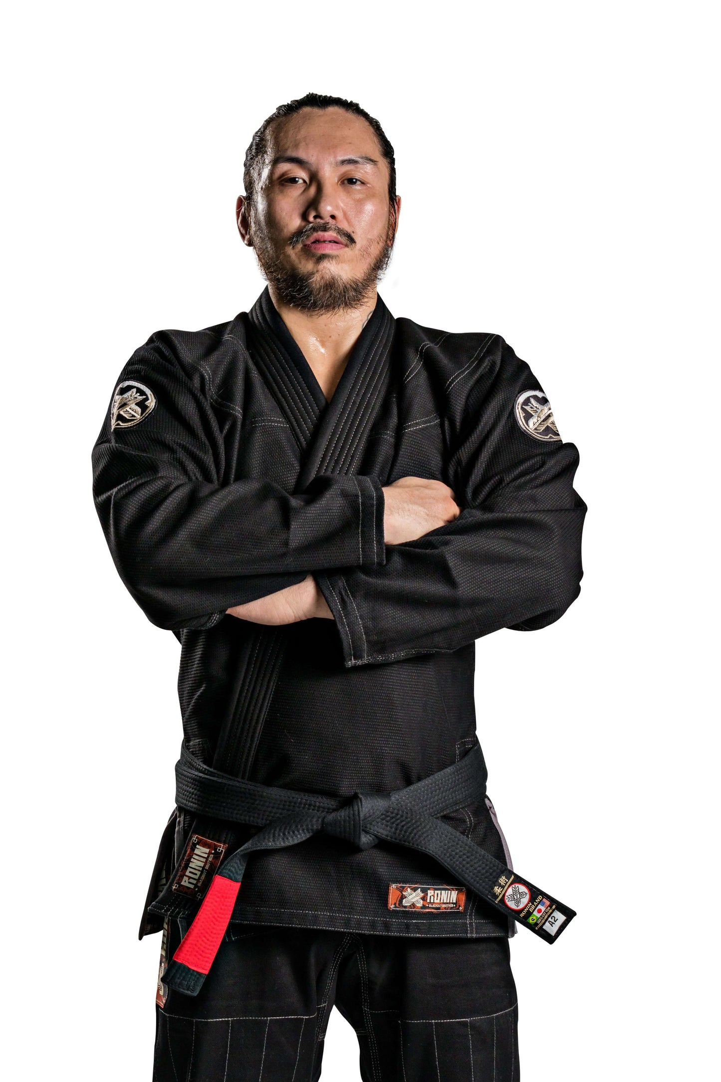 Martial artist wearing the Roninbrand Kurosawa BJJ Gi in black, showcasing strength and readiness for battle.