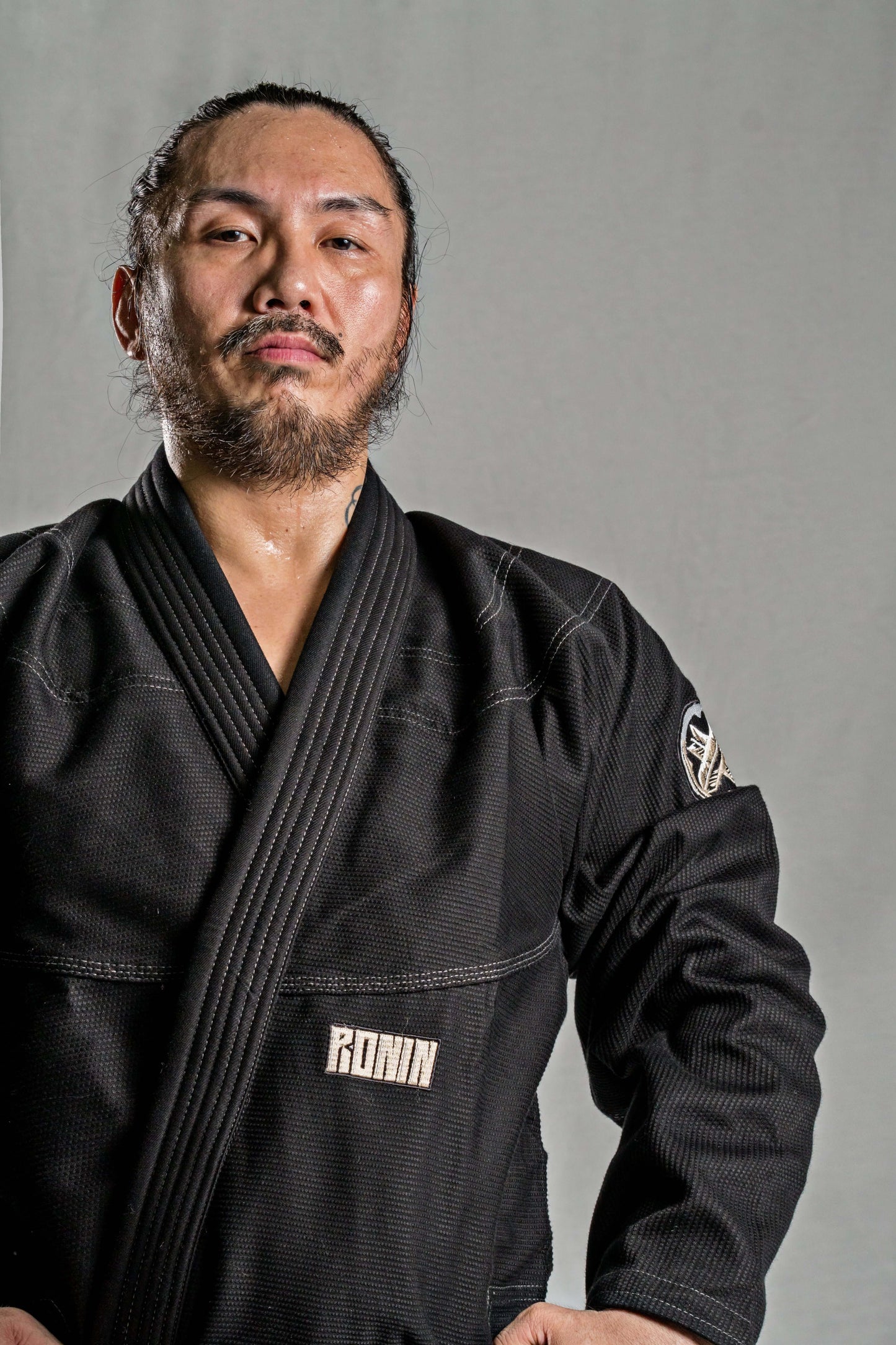 Man wearing Roninbrand Kurosawa BJJ Gi in black, showcasing durability and style for Brazilian Jiu Jitsu fighters.