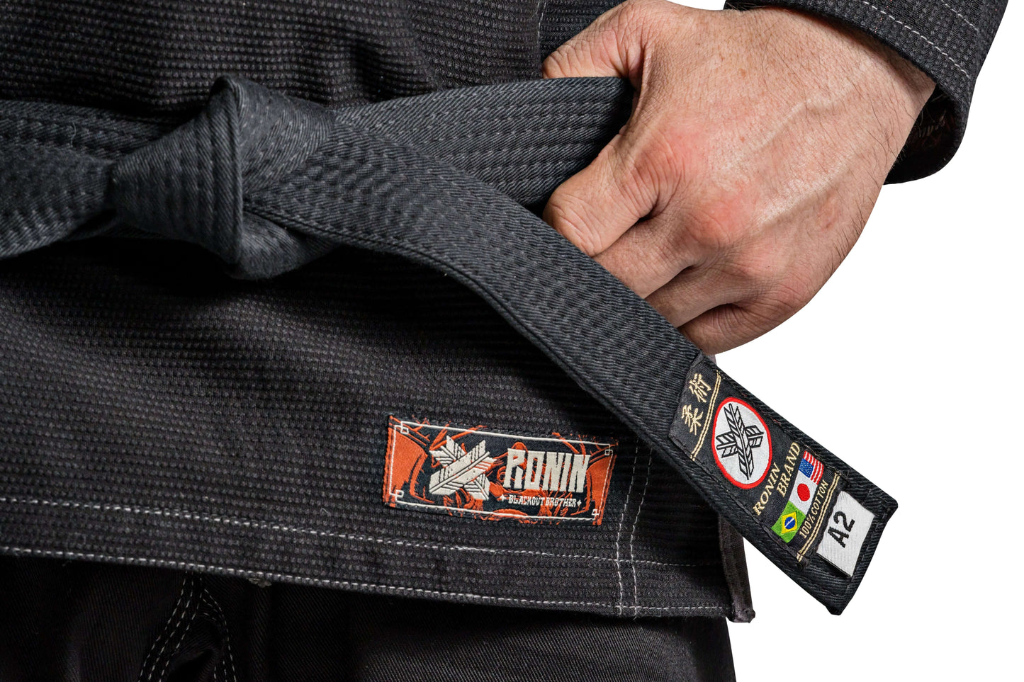 Close-up of Ronin Kurosawa BJJ Gi showing black fabric, belt, and logo details for professional Brazilian Jiu Jitsu.