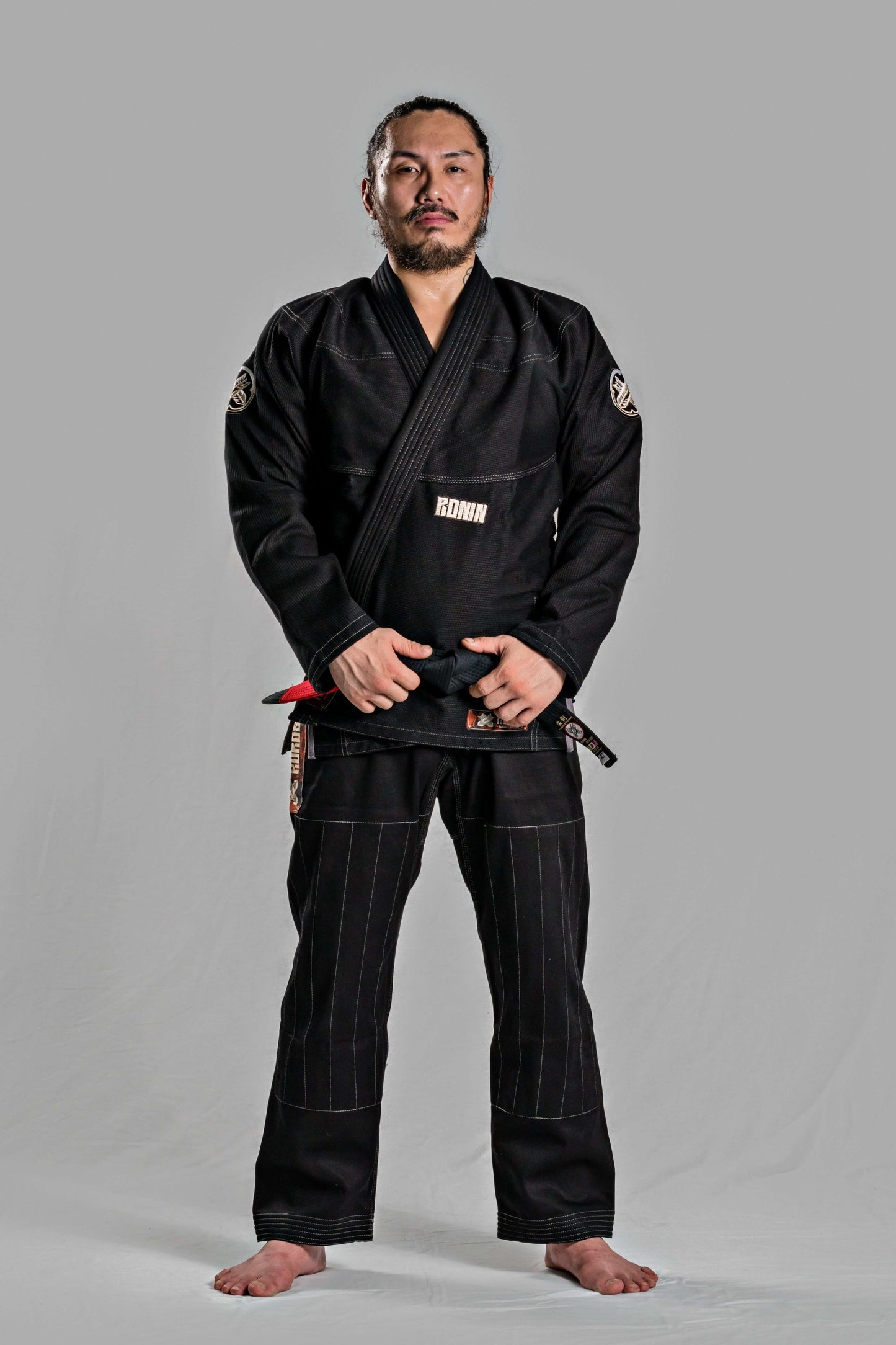 Man wearing Roninbrand Kurosawa BJJ Gi in black, showcasing professional Brazilian Jiu Jitsu attire designed for optimum comfort and fit.