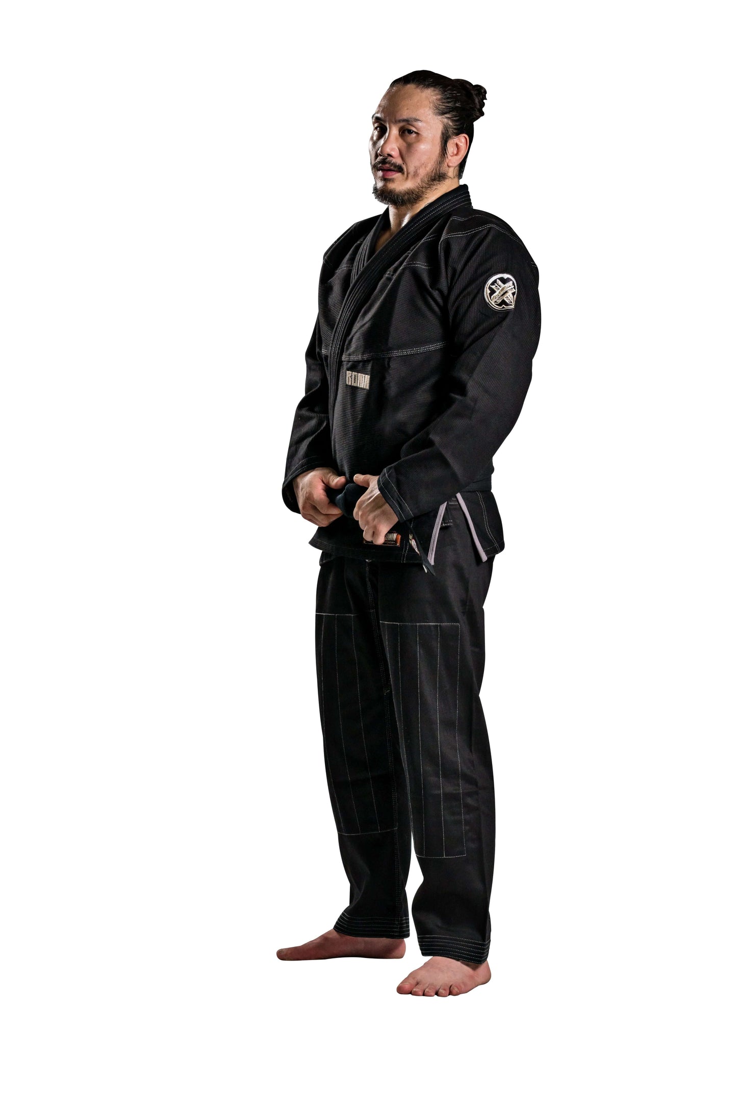 Man in black Roninbrand Kurosawa BJJ Gi showcasing professional Brazilian Jiu Jitsu gear for fighters.