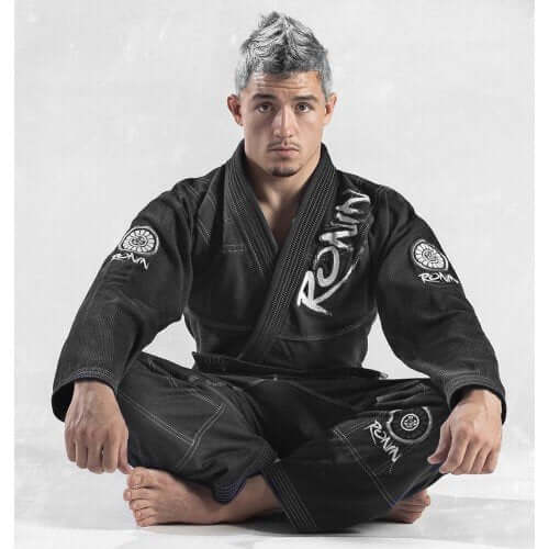 Roninbrand Samurai Ghost BJJ Gi in charcoal worn by a male athlete seated in traditional pose, showcasing style and comfort.