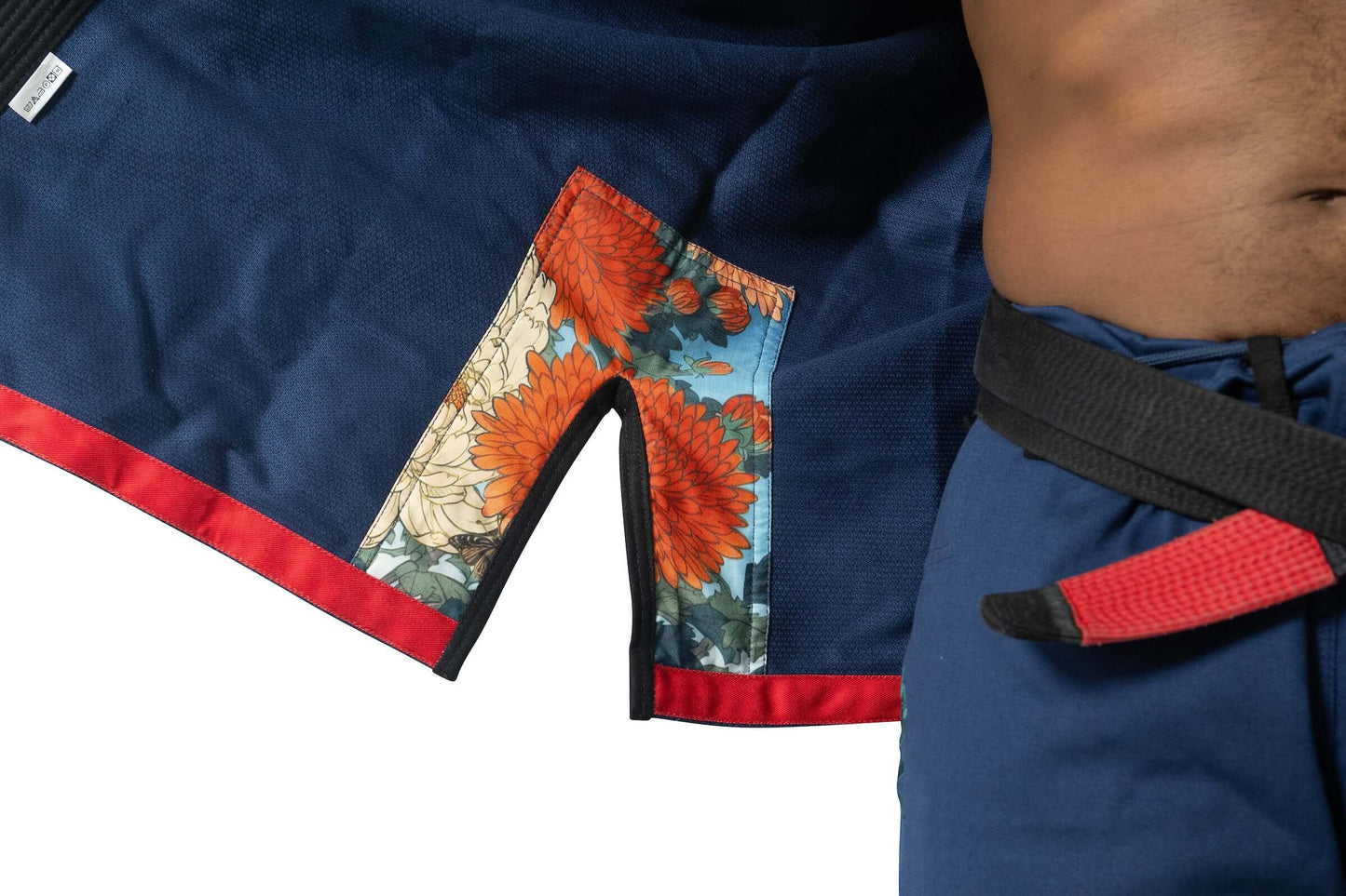 Close-up of Roninbrand Shinsei Yūgure BJJ Gi in navy, featuring vibrant floral lining and contrasting red trim, ideal for grappling.