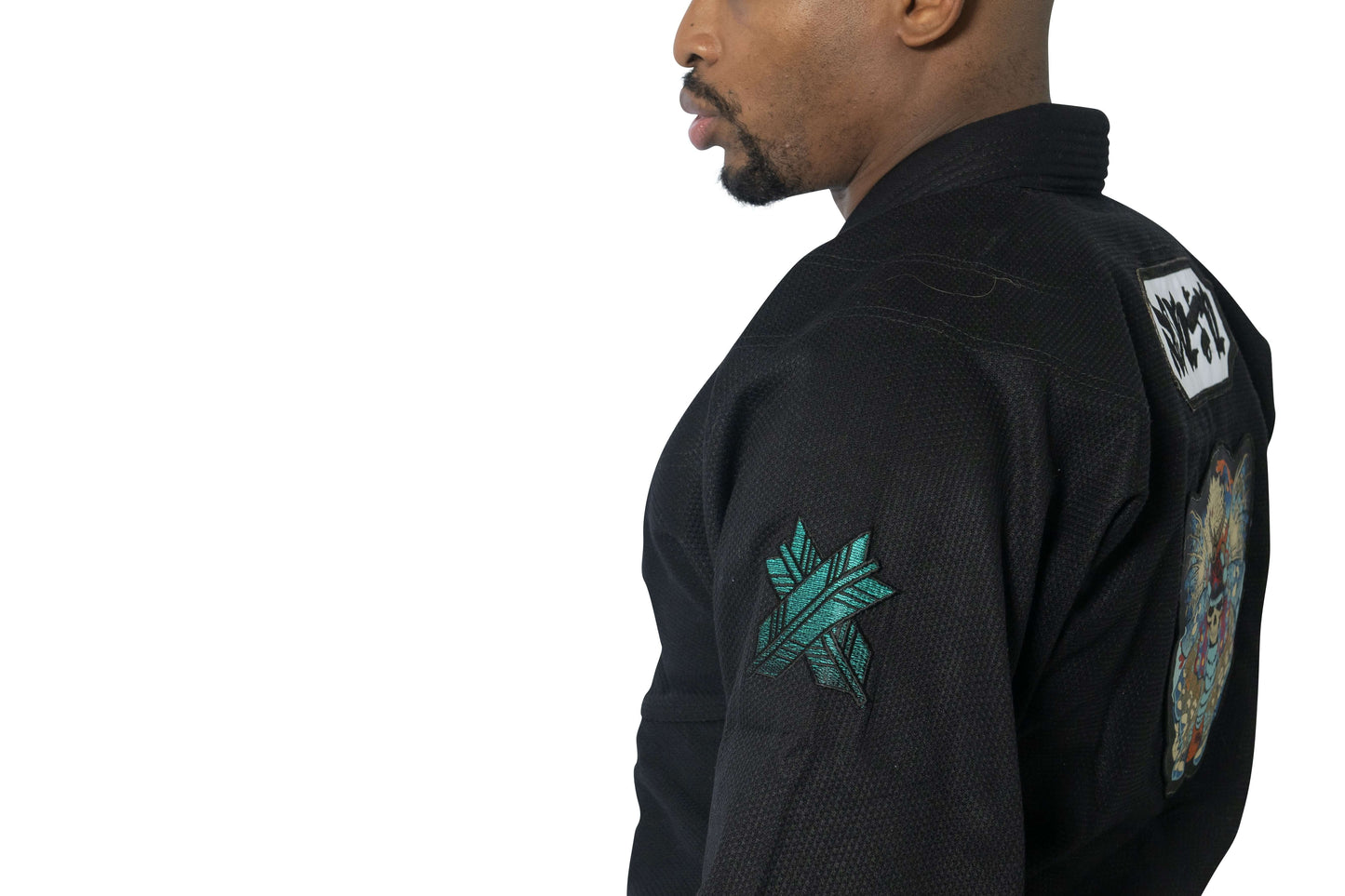 Side view of a man wearing the Roninbrand Shinsei Yūgure Black BJJ Gi, showcasing detailed embroidery and design.