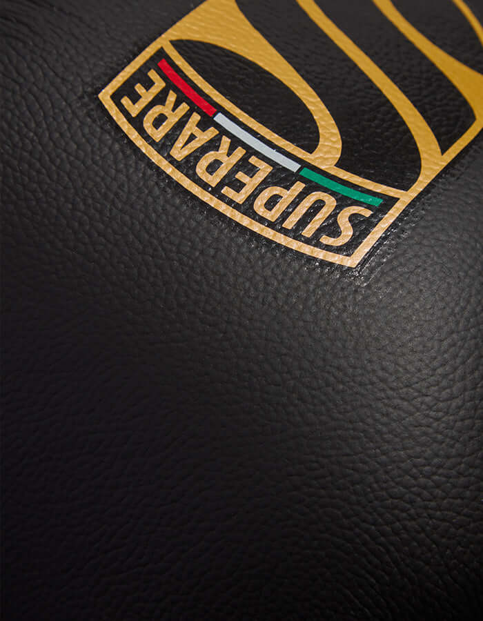 Close-up of Superare logo on matte black leather, showcasing the premium quality of Superare S50 boxing gloves.