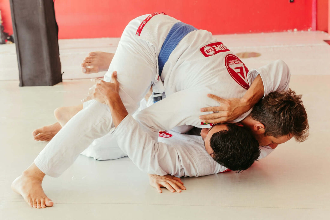 Two athletes sparring in gi, highlighting the importance of gi construction athlete comfort in performance.