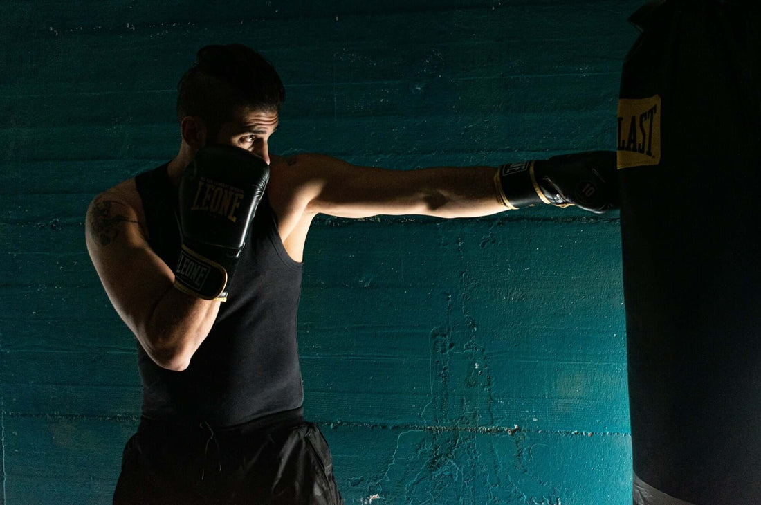 A boxer training with Japanese premium sparring gloves, focused on technique and power in a gym setting.