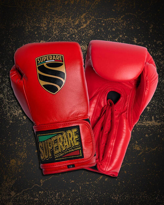 Red boxing gloves displayed against a textured background, perfect for understanding boxing glove weight choices.