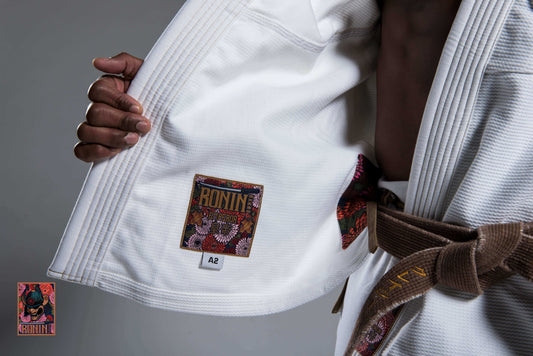 Professional fight gear featuring a BJJ gi with a detailed interior label design.
