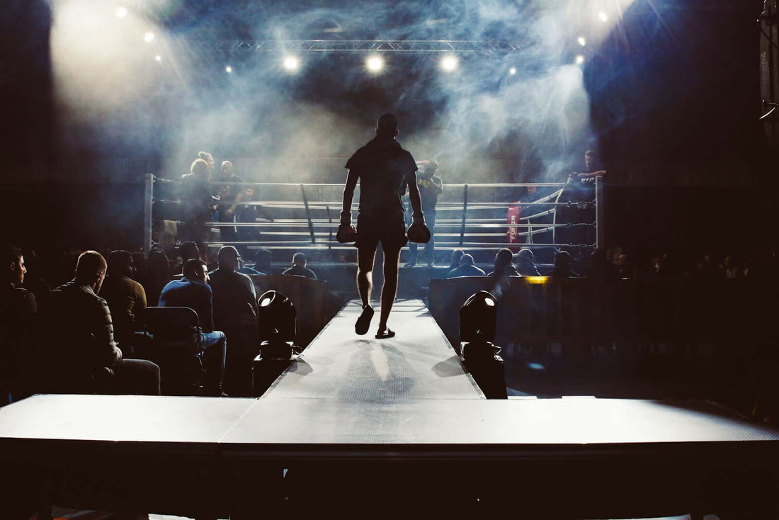 A fighter walking toward the boxing ring, emphasizing the energy of the fight atmosphere.