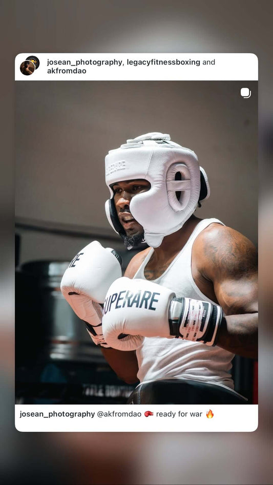 Boxing athlete in training ready for combat with gloves and headgear, embodying the spirit of Boxing.