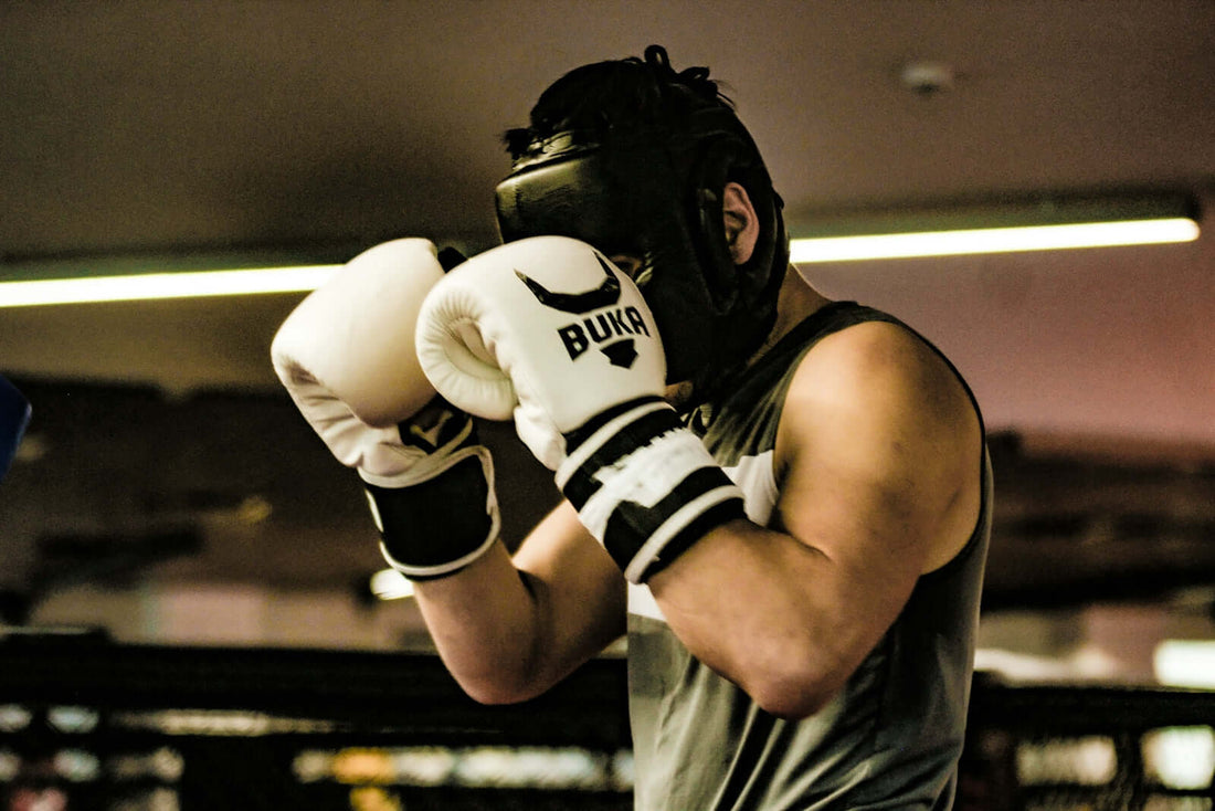 Boxer training with cowhide boxing gloves emphasizing cowhide boxing gloves strength in high-performance setting.