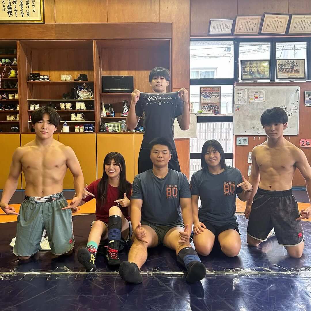 Fighters showcasing professional fight equipment in a training environment.