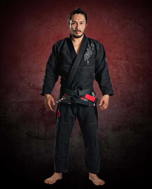 Martial artist in black BJJ gi, showcasing confidence and readiness for training or competition.