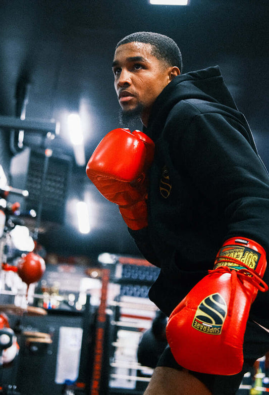 Boxer training in red gloves, focused in a gym setting, capturing the spirit of the Iron Fist Chronicles.