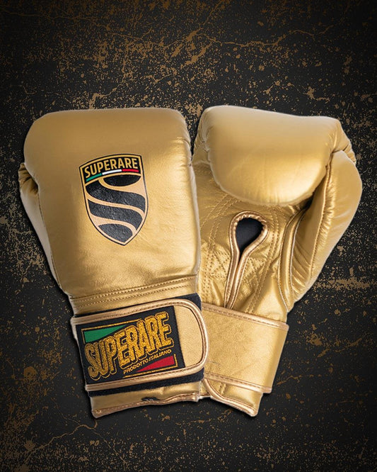 Golden boxing gloves by Superare x Paragon Elite, symbolizing the spirit of boxing legends and championship fights.