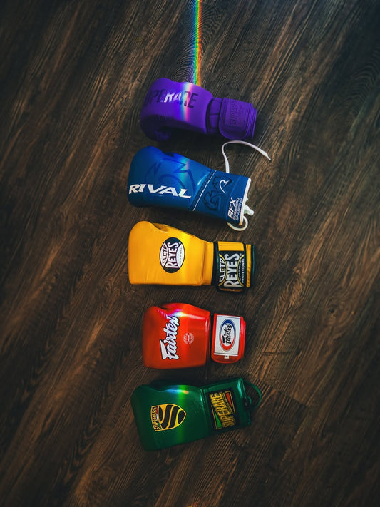 Boxing gloves in various colors showcasing the types of hand wraps best for additional glove protection.