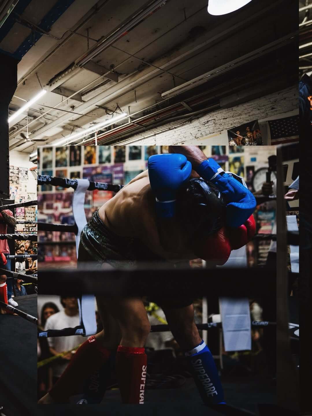 Boxing match featuring two fighters in headgear during a training session in a gym.