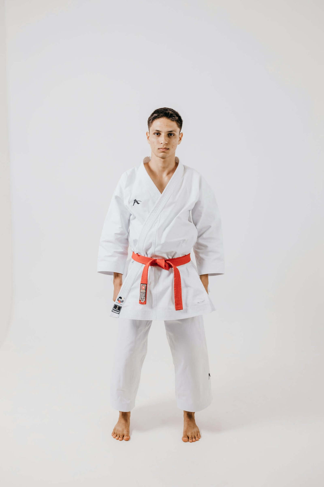 A fighter in a white gi showcasing fight-thermoregulation advancements for improved performance.