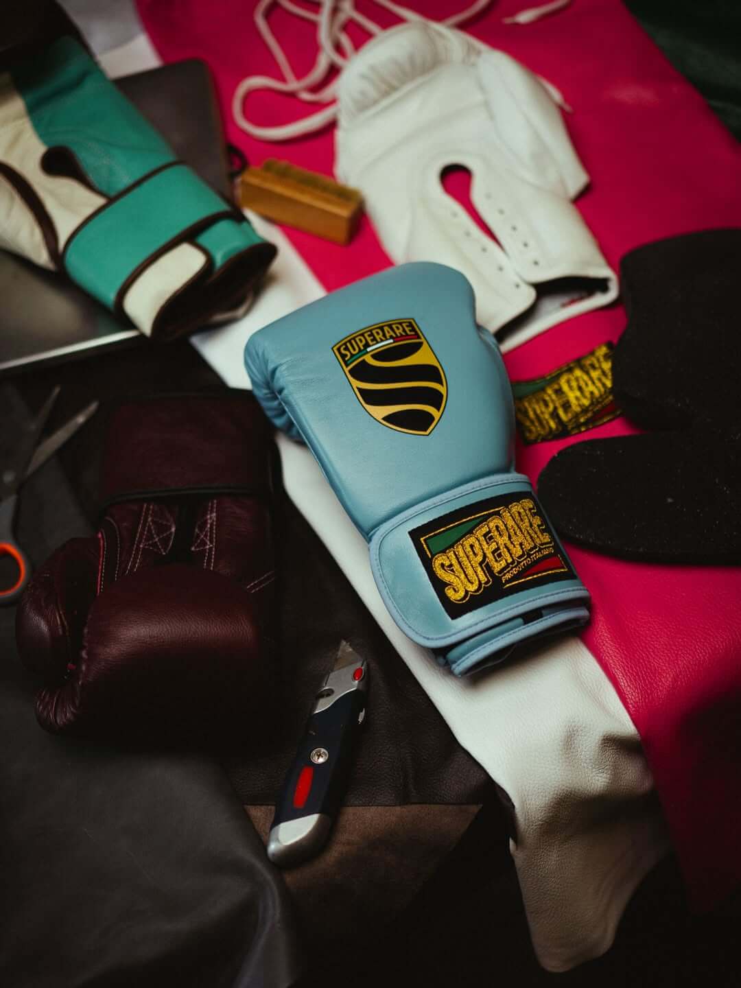 Fight Gear displayed with colorful boxing gloves and gear on a training surface.