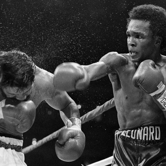 Sugar Ray Leonard throwing a punch at Roberto Durán during their iconic 1980 boxing match at Montreal Forum.