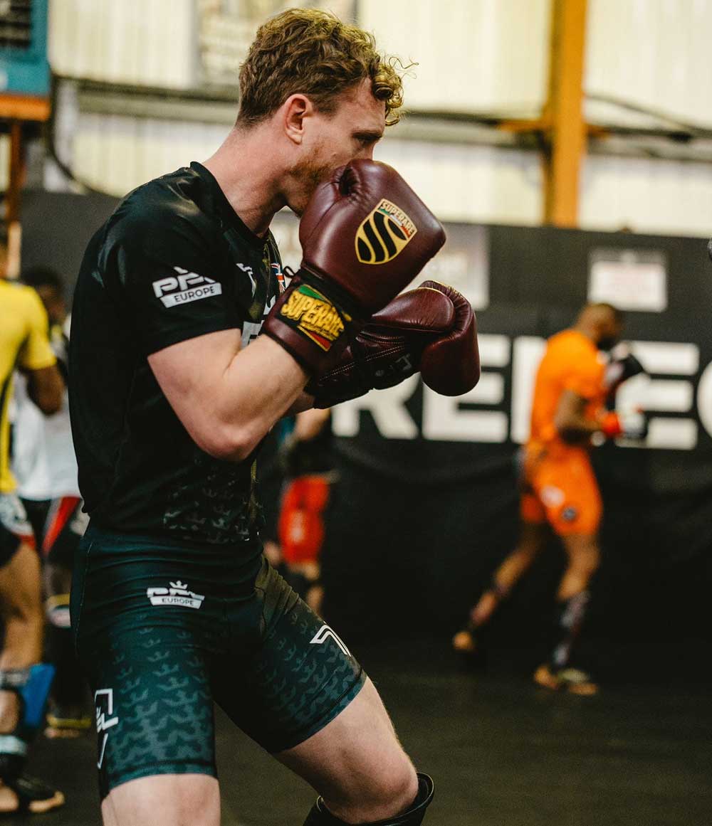 BJJ and Boxing training session featuring fighter in gloves at Paragon x Superare x Ronin gym.