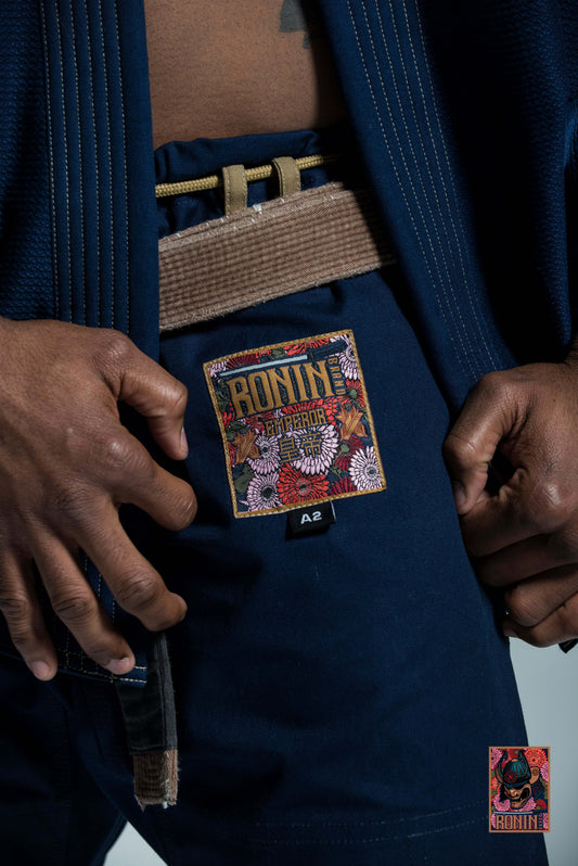 Close-up of Roninbrand Navy Emperor BJJ Gi, highlighting the detailed logo and belt for grappling excellence.