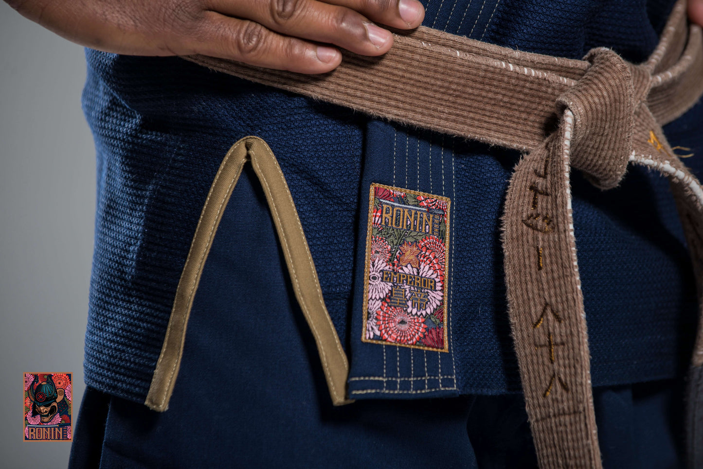 Close-up of Roninbrand Navy Emperor BJJ Gi with intricate details, showing logo and belt for optimal grappling.