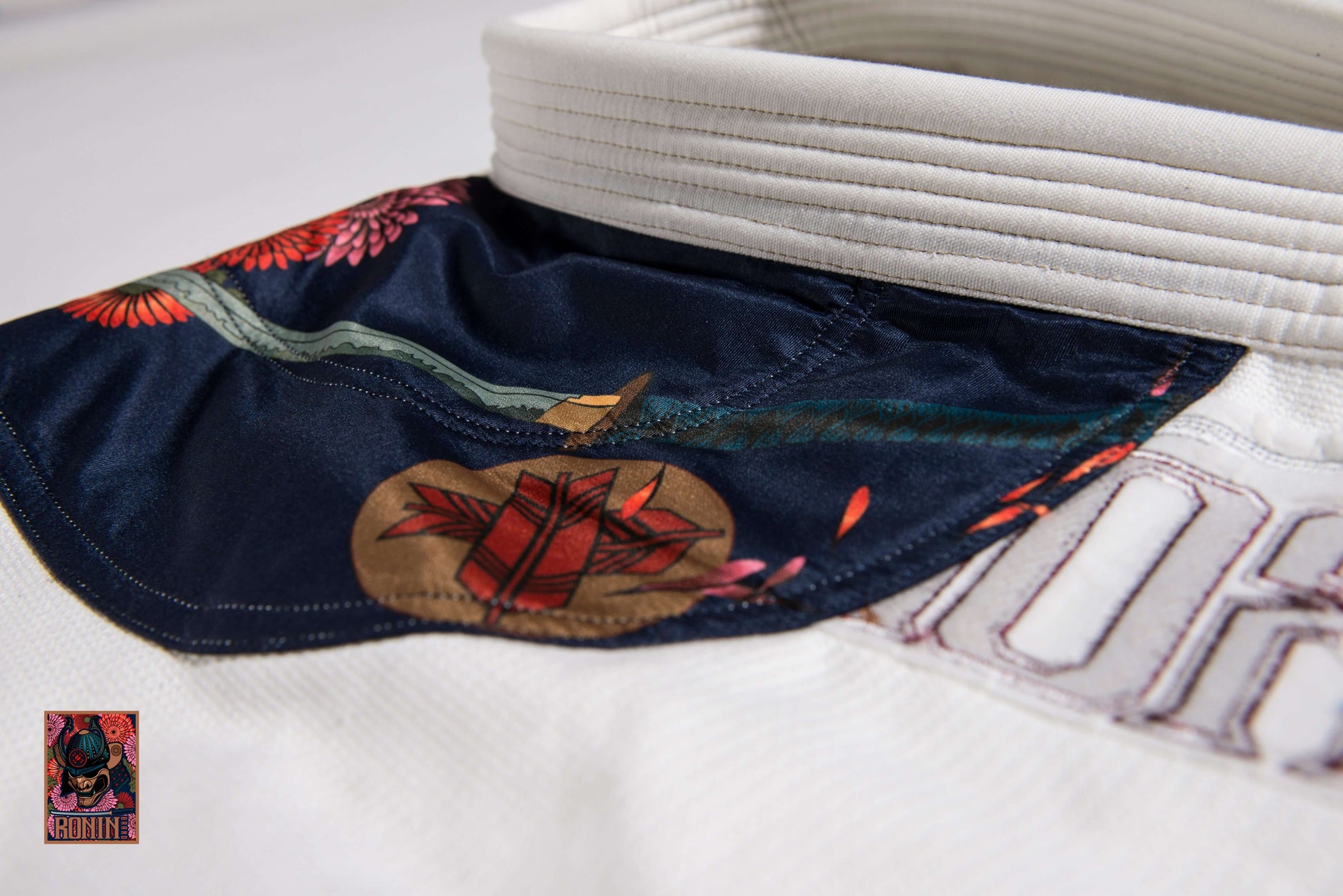 Emperor BJJ Gi white collar with intricate chrysanthemum embroidery, symbolizing strength and resilience.